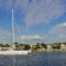 Yacht cruising in scenic Tampa Bay with waterfront homes and clear skies.