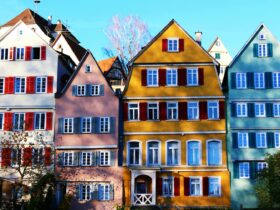 Vibrant facades of traditional houses in Tübingen's historic center, under a clear daytime sky.