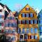Vibrant facades of traditional houses in Tübingen's historic center, under a clear daytime sky.