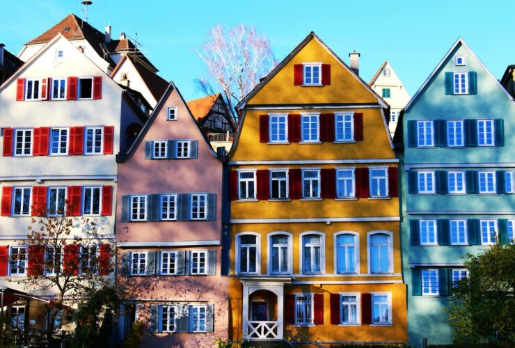 Vibrant facades of traditional houses in Tübingen's historic center, under a clear daytime sky.