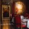 Luxurious dining room in a French restaurant with red chairs and chandeliers in Vonnas.