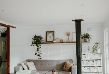 Warm and inviting Scandinavian-style living room with neutral decor and indoor plants.
