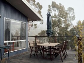 A serene outdoor terrace with wooden furniture on a foggy day, ideal for tranquility.