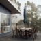 A serene outdoor terrace with wooden furniture on a foggy day, ideal for tranquility.