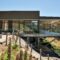 A modern house with a glass balcony overlooking the mountains