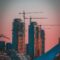 gray building crane photo during sunset