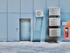 a couple of air conditioners sitting on the side of a building