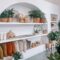 a room filled with lots of plants and potted plants