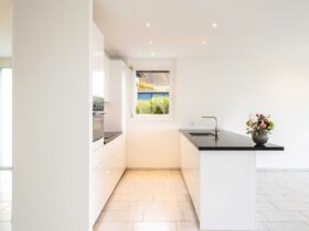 white ceramic bathtub near white wall
