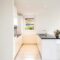 white ceramic bathtub near white wall