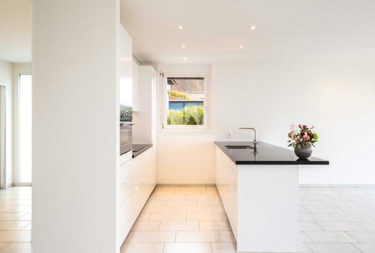 white ceramic bathtub near white wall