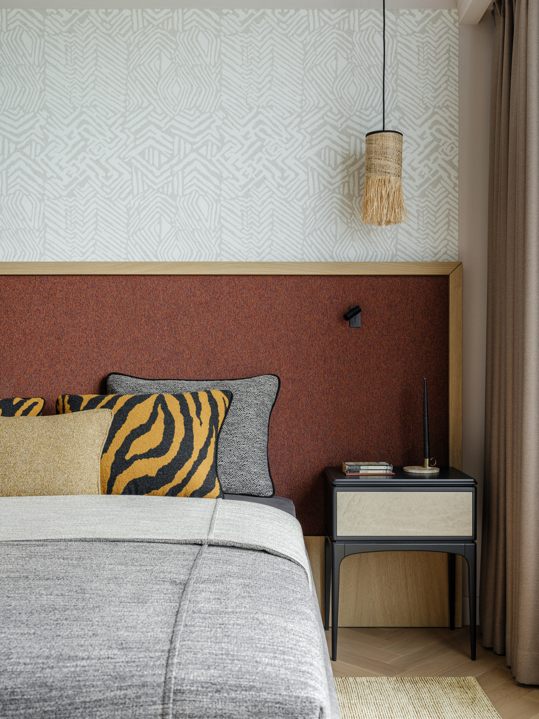 close-up of bed headboard with tiger stripe and ochre pillows