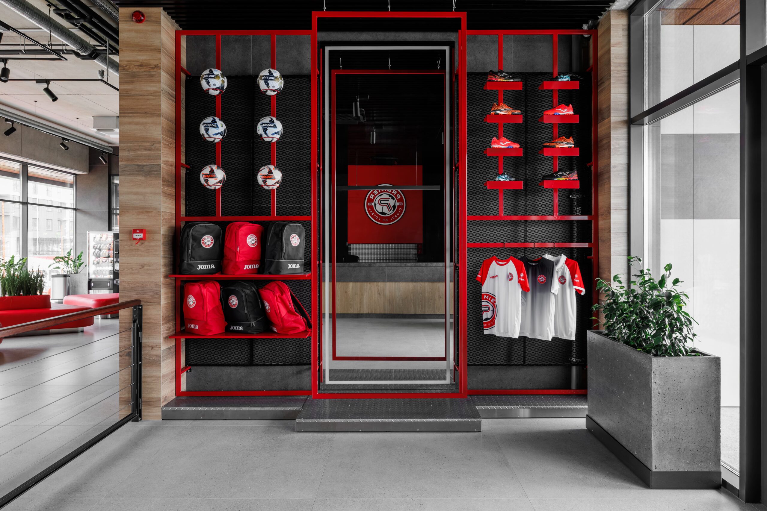 Club shop entrance with red-framed football merchandise display
