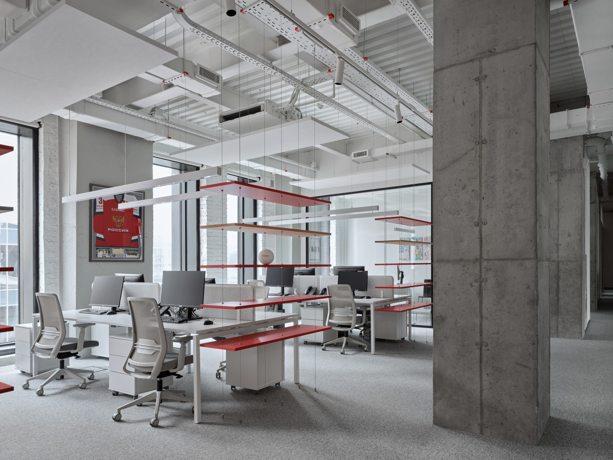 DKC office Moscow expansive open office with mirrored walls and red accent tables