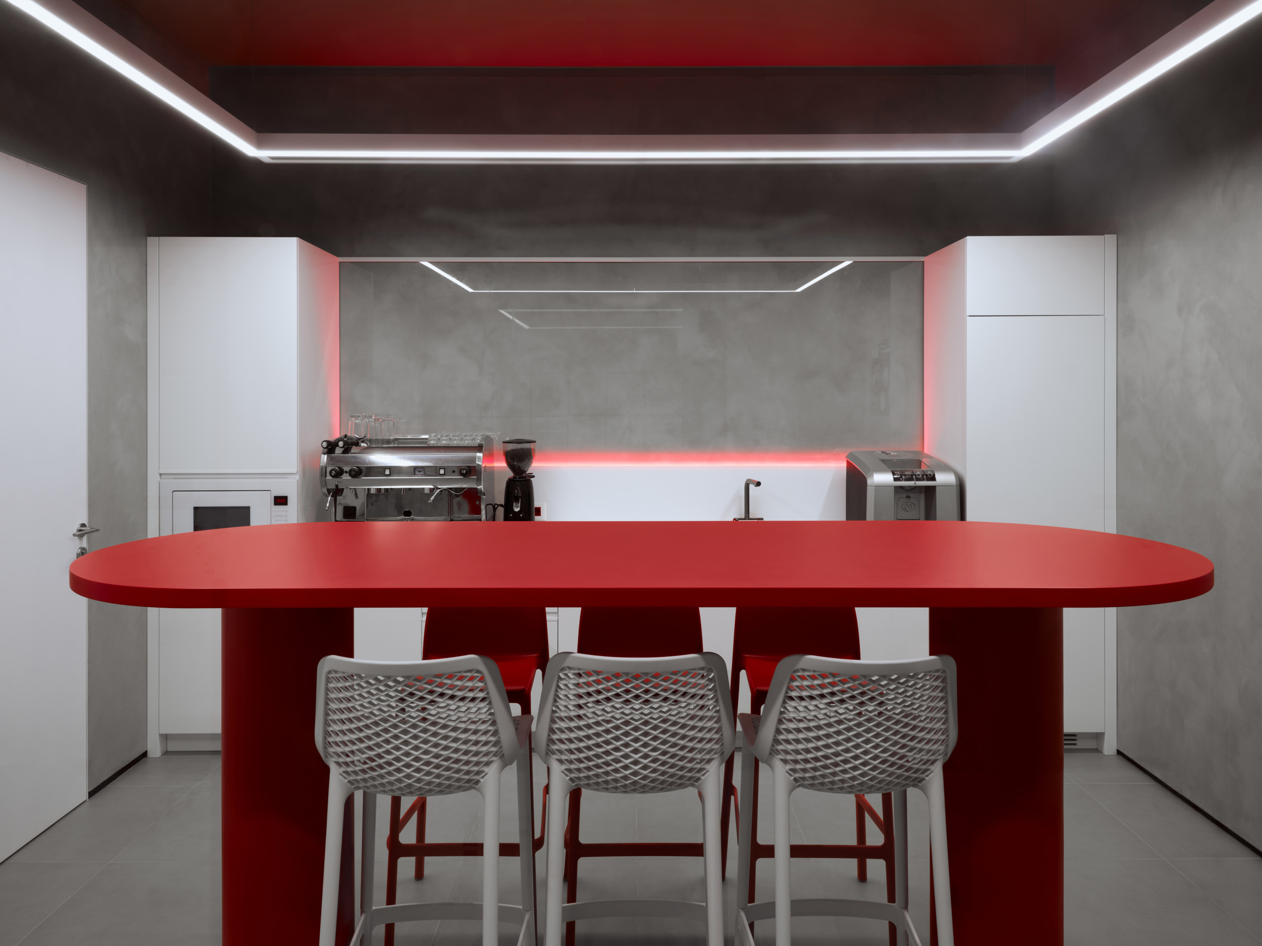 DKC office Moscow red oval meeting table with metal mesh chairs and industrial ceiling