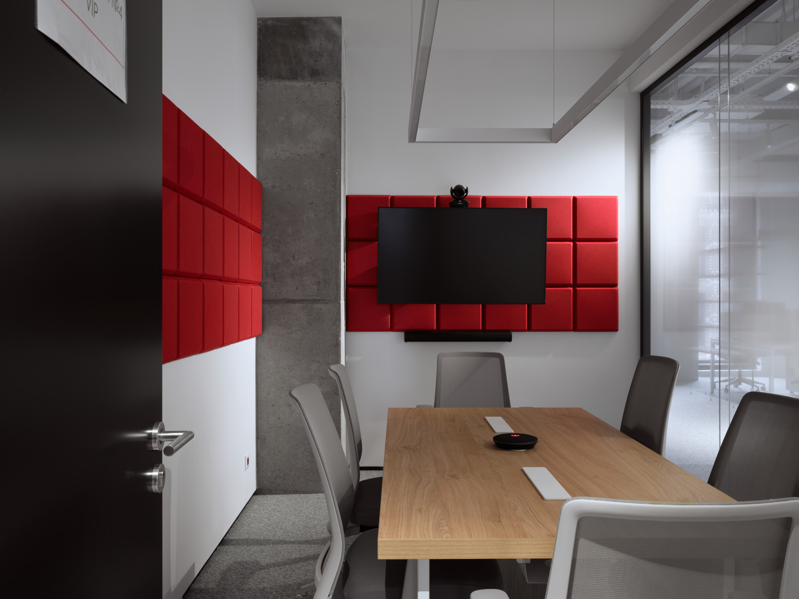 DKC office Moscow lounge with red seating cubes and warm timber table