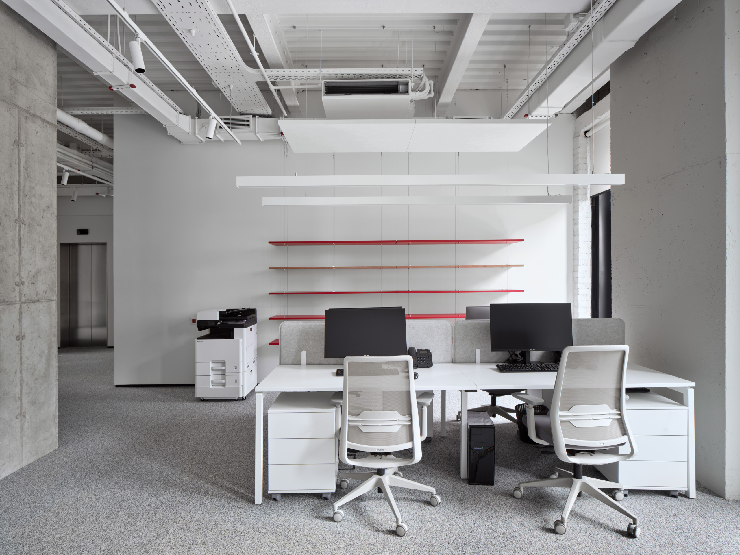 DKC office Moscow open plan workstations with white furniture and red accent lighting