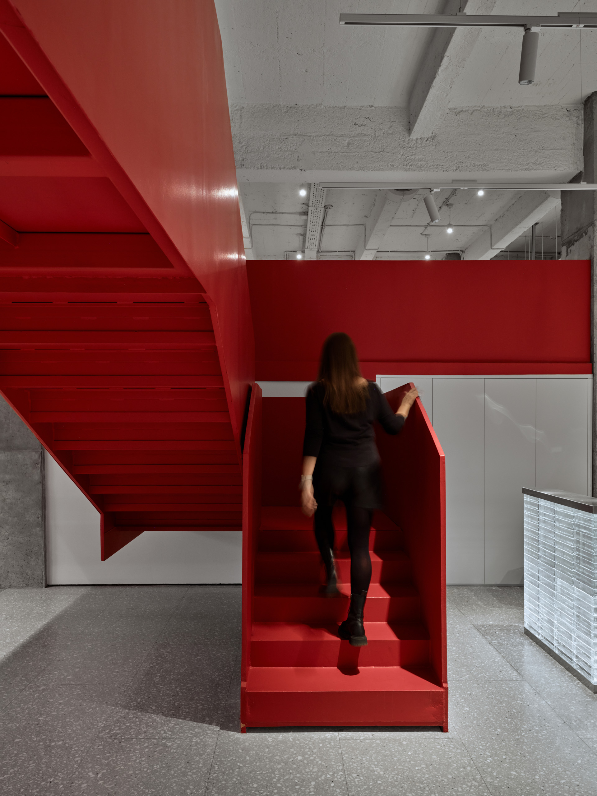 DKC office Moscow red angular sculpture in white atrium space with pedestrian