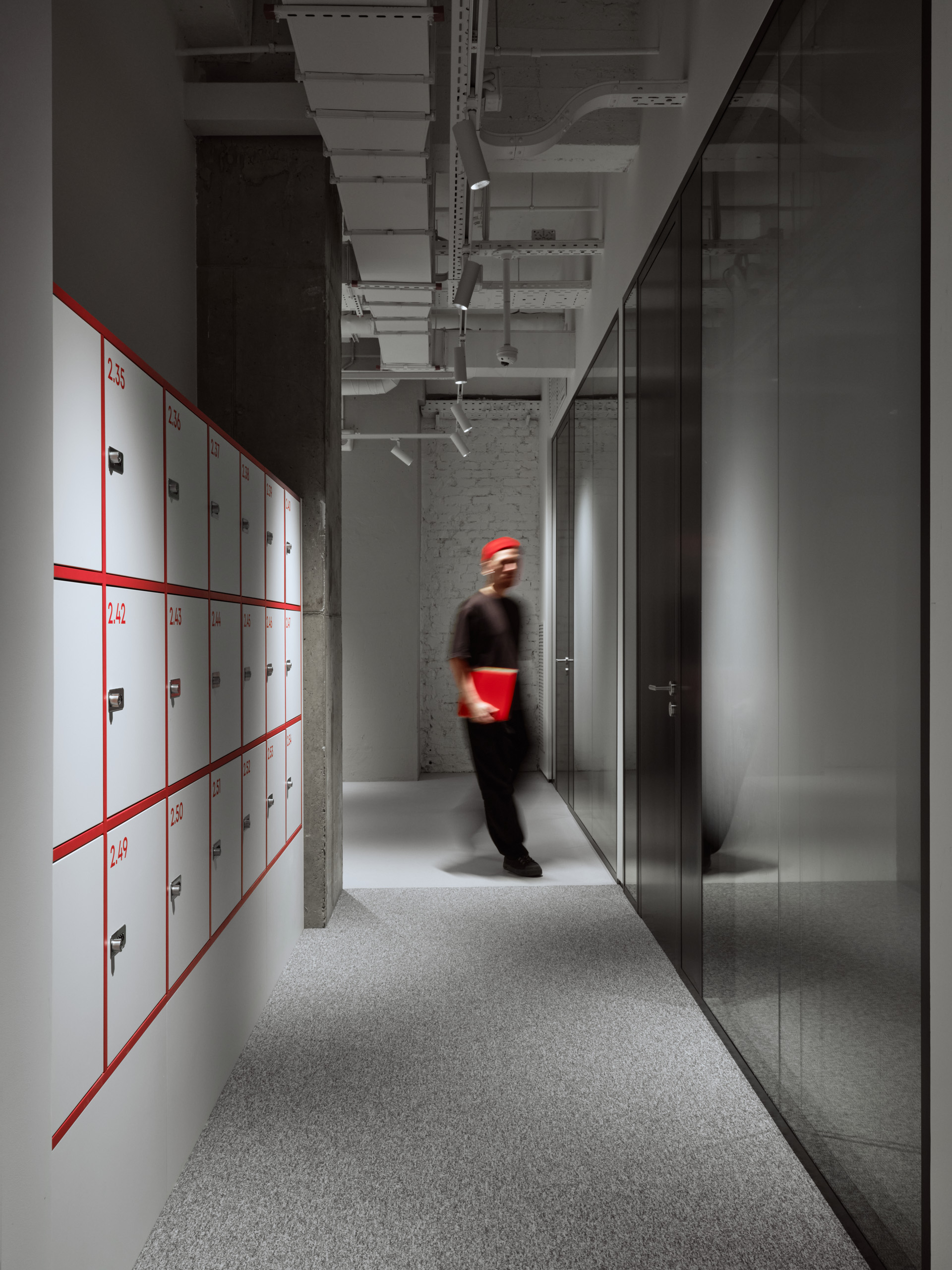 DKC office Moscow corridor with red linear wall accents and exposed concrete