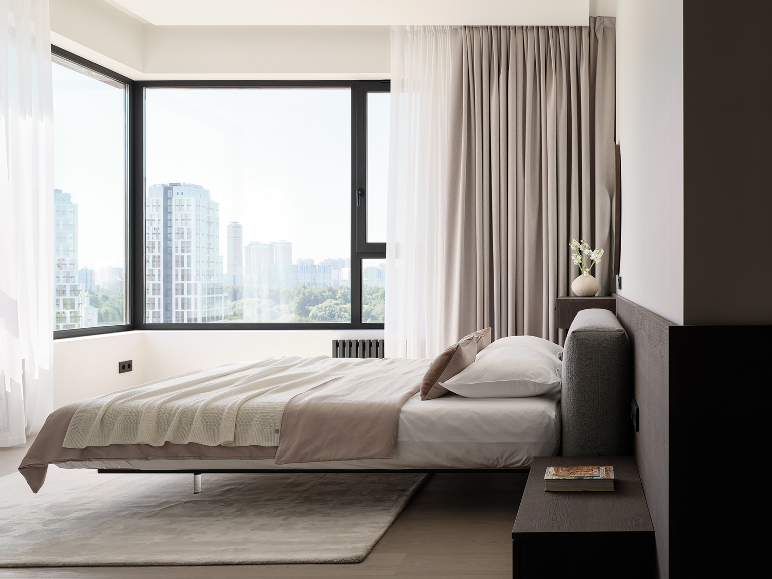 Master bedroom with floating bed, corner window, and city view