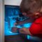 a man working on a pipe in a cabinet