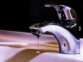 stainless steel faucet on white ceramic sink
