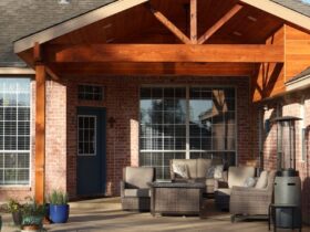 House exterior with covered patio, outdoor furniture, and swimming pool.