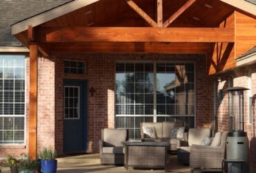 House exterior with covered patio, outdoor furniture, and swimming pool.