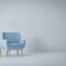 a blue chair and a yellow lamp in a white room