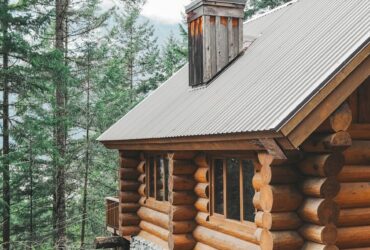 brown wooden house surrounded by green trees during daytime