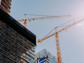 yellow crane near building during daytime