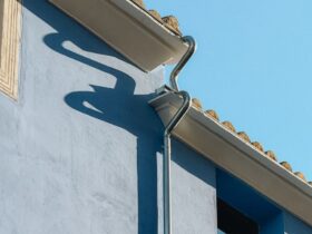 A blue building with a clock on the side of it