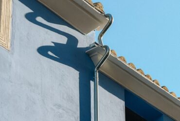 A blue building with a clock on the side of it