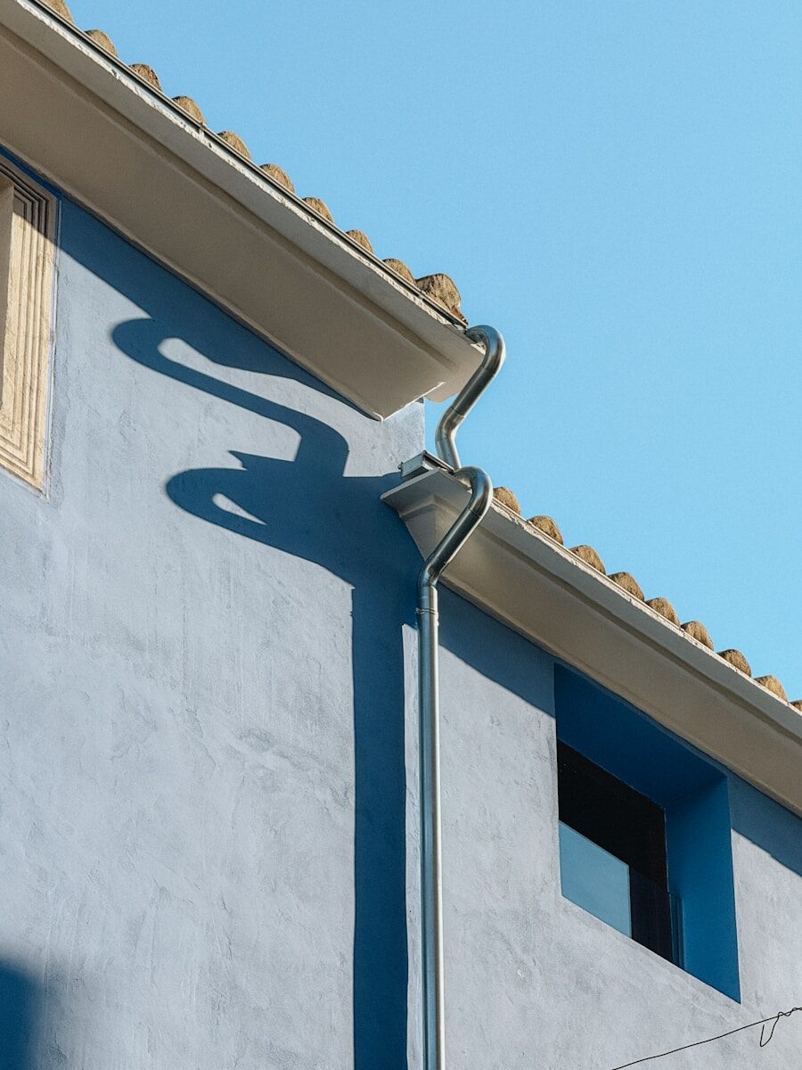 A blue building with a clock on the side of it