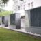 Four industrial air conditioning units lined up outside building