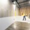 Workers painting a large industrial floor white