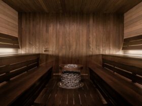 a wooden saunage with a bucket of towels on the floor