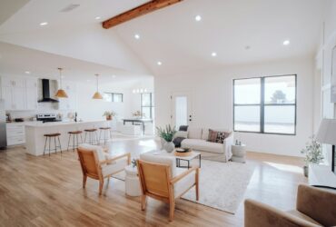 a living room filled with furniture and a kitchen