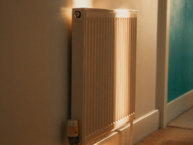 A wall-mounted radiator warmly lit by sunlight in a cozy indoor setting.