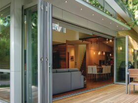 Modern home with folding glass doors opening to deck