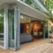 Modern home with folding glass doors opening to deck