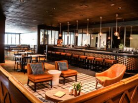 a bar with chairs and a bar counter