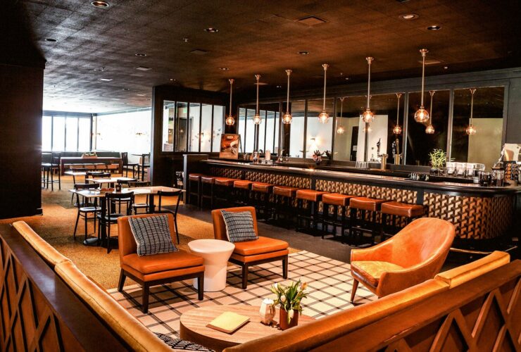 a bar with chairs and a bar counter