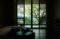 Dark room with large window and nature view