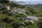 A hillside village overlooks a bay with distant islands